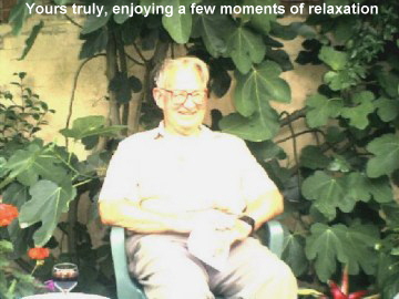 Yours, truly, enjoying a few moments of relaxation � surrounded by his Fig trees. (This must surely be a true Englishman's garden! -- John's comments)